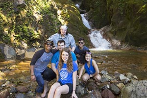 Six student in front of a waterfall in Costa Rica.
